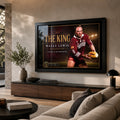 Black framed Wally Lewis wall art displayed in a warm contemporary living room above a long timber console and sofa.