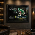 Black framed The Leap NFL wall art displayed in a dark wood man cave with warm shelf lighting.