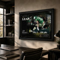 The Leap Saquon Barkley football wall art displayed in a modern office above a dark desk.