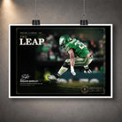 Unframed The Leap Saquon Barkley NFL wall art shown as a print with a white border and hanging clips.