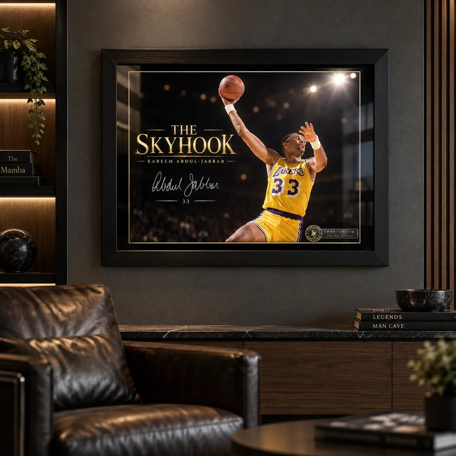 Kareem Abdul-Jabbar The Skyhook wall art displayed in a dark man cave with black leather seating and warm shelf lighting.