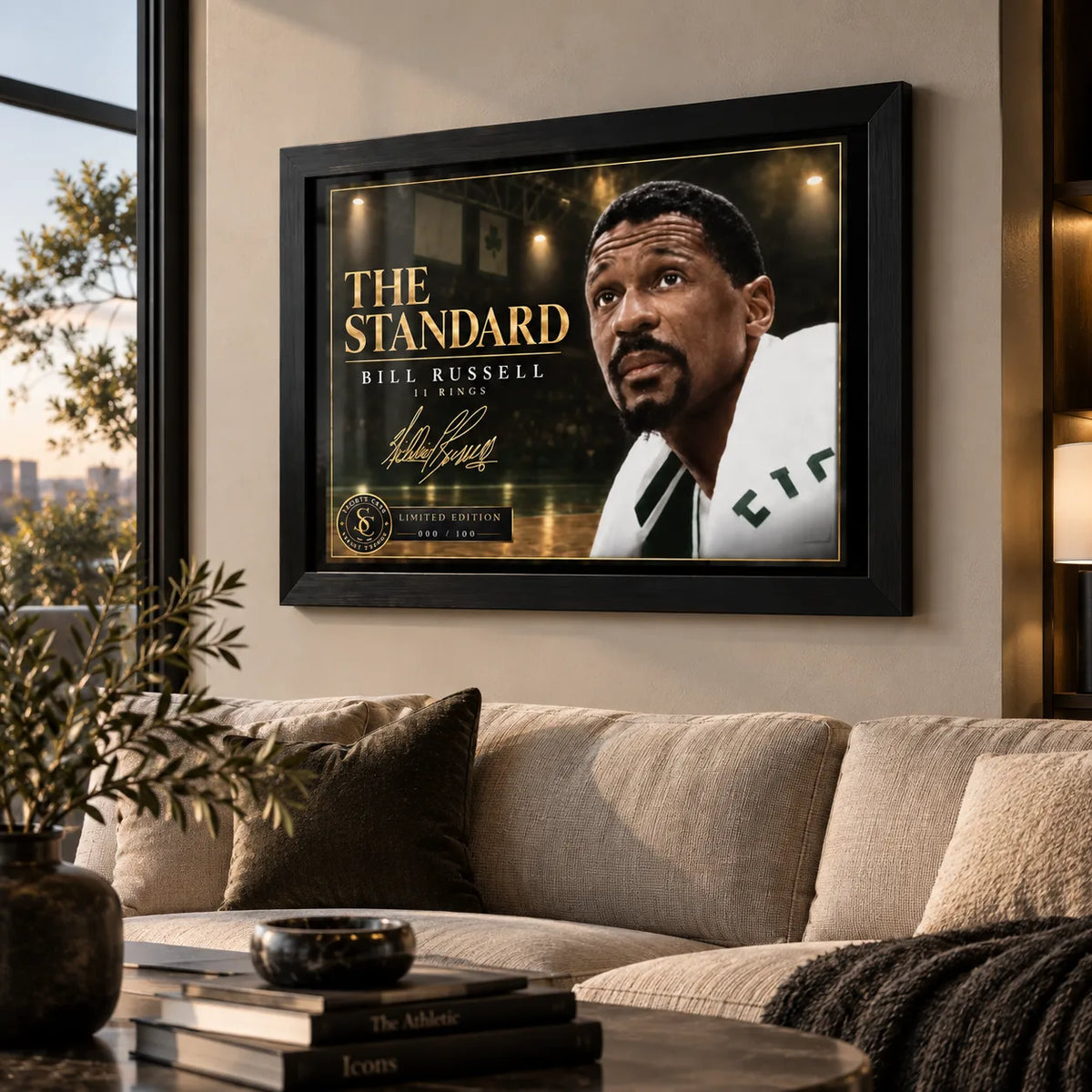 Bill Russell wall art displayed above a sofa in a warm living room with the black framed The Standard basketball design.