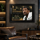 Bill Russell wall art displayed in a dark man cave setting with the black framed The Standard basketball design.