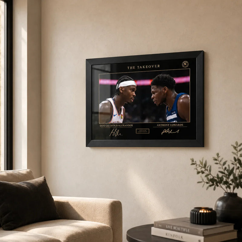 The Take Over basketball wall art in a black frame displayed on a warm neutral living room wall.