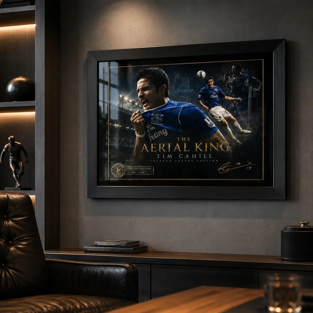 Black framed Tim Cahill Everton wall art on a dark man cave wall with shelving and warm ambient lighting.