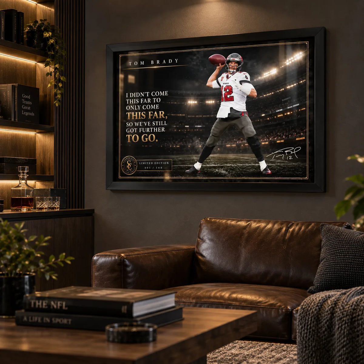Tom Brady NFL wall art in a black frame displayed in a dark man cave with leather seating and warm shelf lighting.