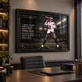 Tom Brady NFL wall art in a black frame displayed above a desk in a premium home office with warm ambient lighting.
