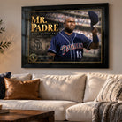 Black-framed Tony Gwynn Mr. Padre baseball tribute on a warm living-room wall above a cream-coloured sofa.