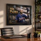 Black-framed Tony Gwynn Mr. Padre tribute mounted above the desk in a home office with a leather chair.