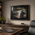 Valentino Rossi The Doctor wall art in a black frame displayed above a warm timber office desk.