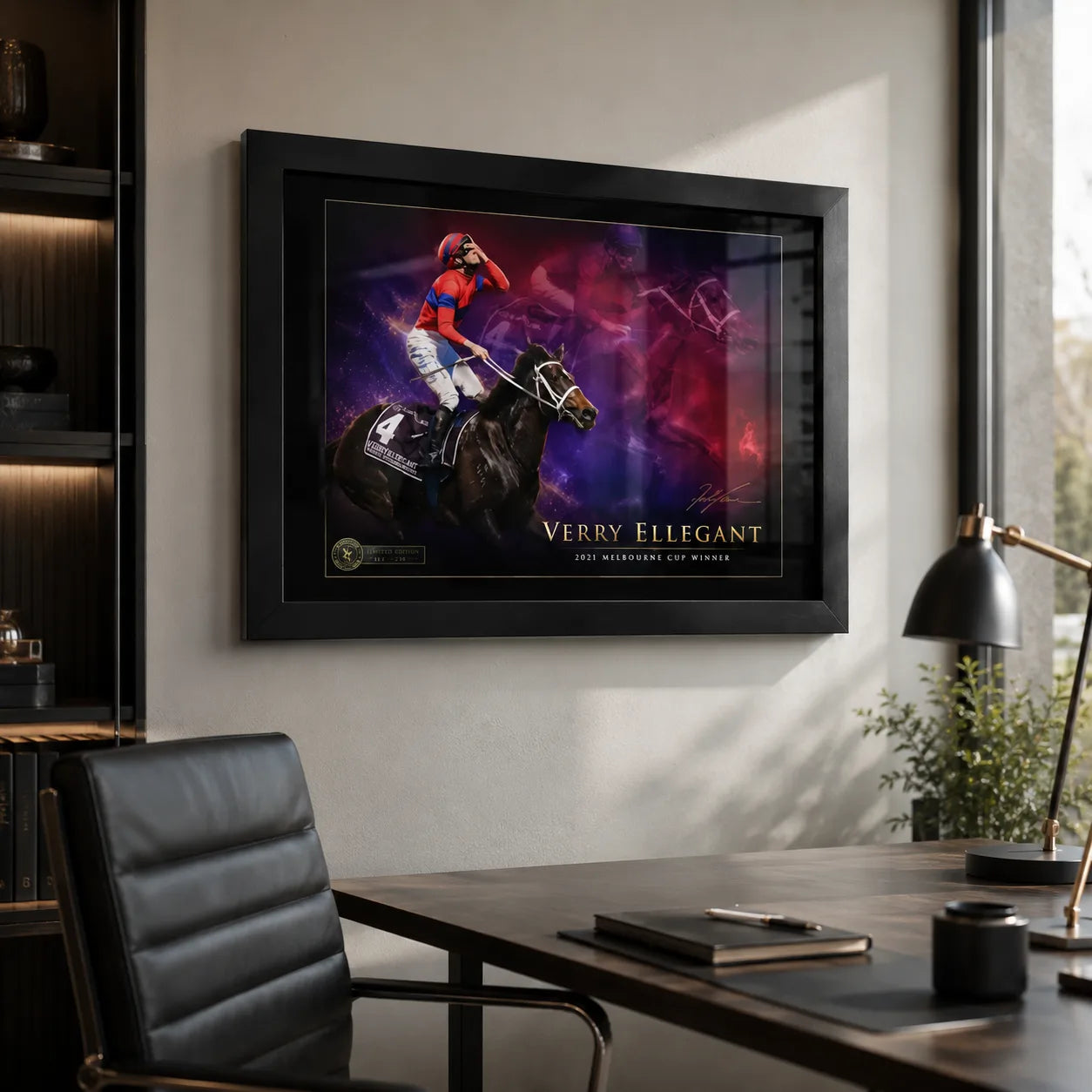 Black framed Verry Elleegant 2021 Melbourne Cup wall art displayed in a modern home office above a dark timber desk.