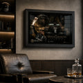 Black framed motorsport wall art styled in a dark man cave with leather seating, warm shelving and collector mood.