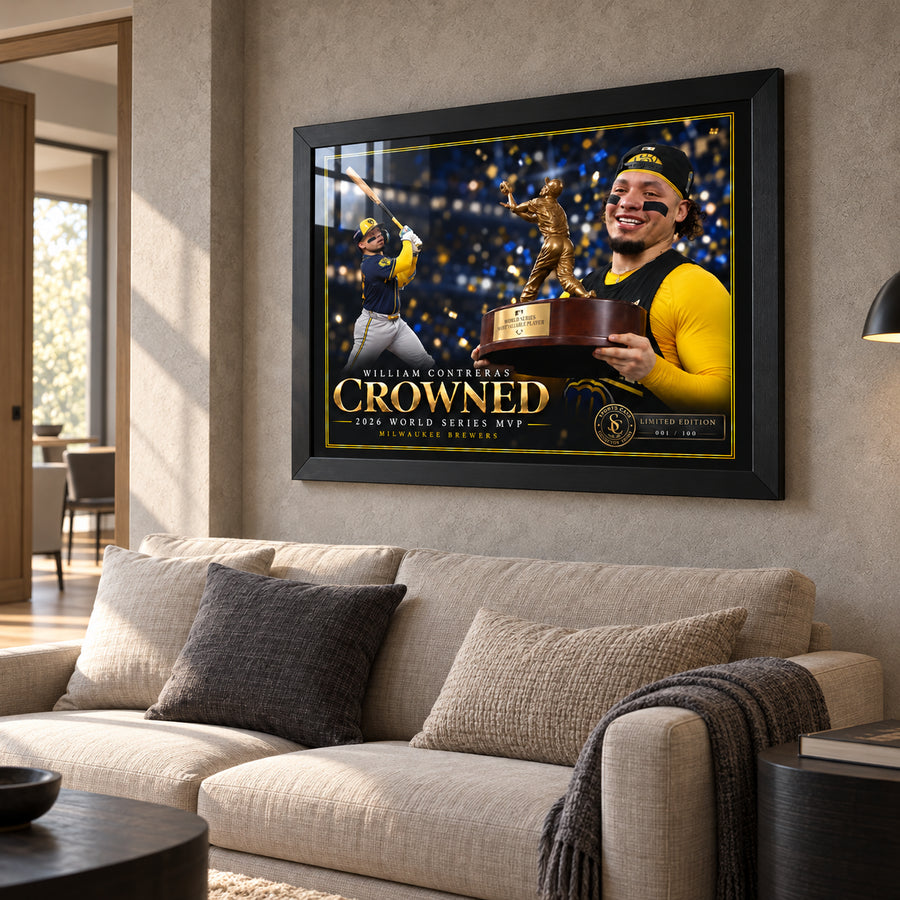 William Contreras Crowned edition in a black frame above a light fabric sofa in a sunlit living room.