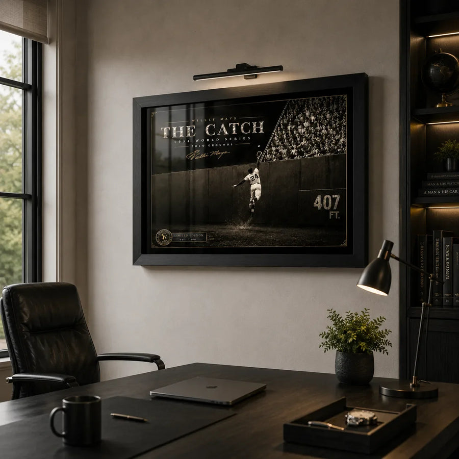 Willie Mays The Catch framed baseball wall art displayed in a modern executive office with dark timber shelving.